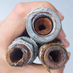 Image shows well water pipes severely clogged with rust and sediment, better call barlow